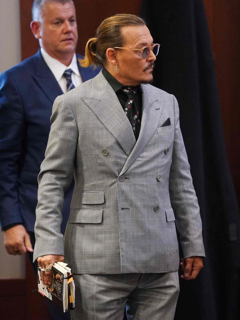 Depp returns to his seat in court on Monday. Picture: Shawn Thew/POOL/AFP