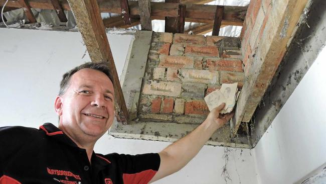 Maryborough home owner Nick Buxton found an old autograph book in the roof of his bathroom while renovating. Picture: Boni Holmes