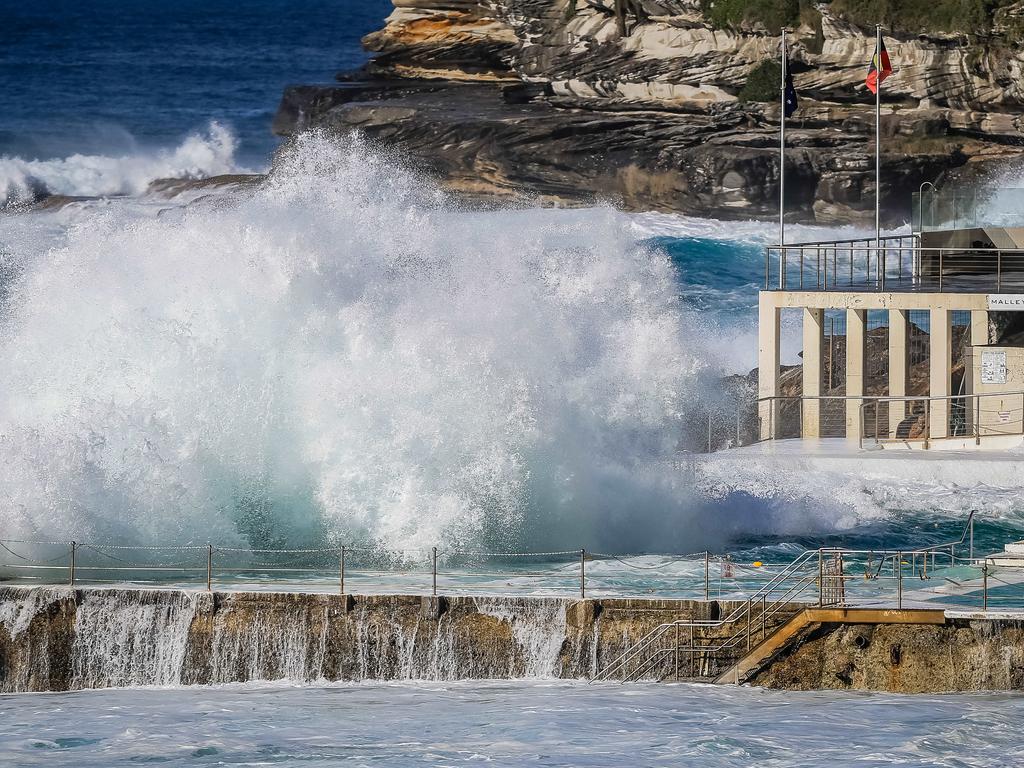 The Icebergs pools at Sydney’s Bondi Beach are seen coated with massive waves. Picture: Craig Greenhill