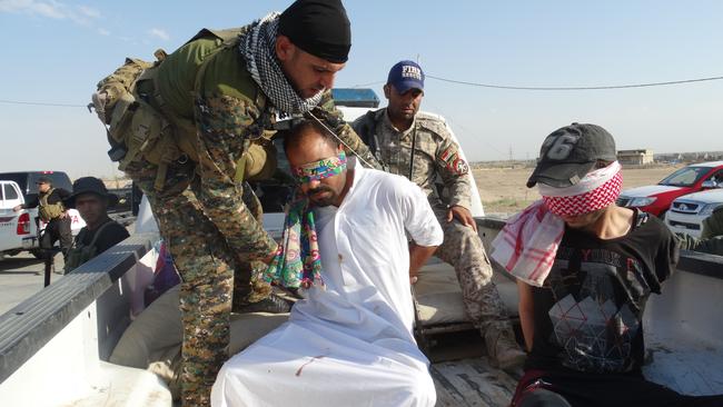 <span class="creditattribution">AP</span>                     In Iraq meanwhile, an Iraqi security team handcuffs and blindfolds suspected Islamic State militants at a refugee camp near Fallujah.