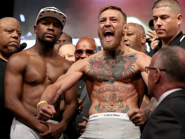 UFC lightweight champion Conor McGregor (R) screams after the face off.