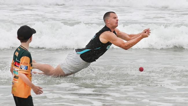 Jack Wildermuth of Brisbane Heat had his “softest landing ever” after missing a catch in a game of beach cricket against the Helensvale Hawks Juniors. Picture: Glenn Hampson