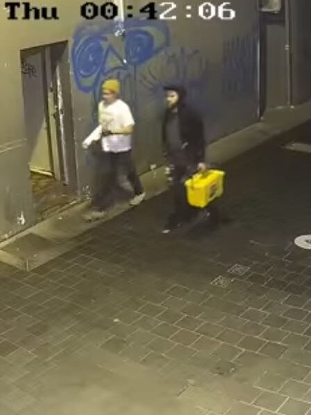 Police would like to speak to these two men about the Tony Abbott posters.