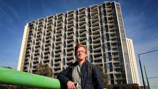 Resident Alex Storer outside the Lacrosse tower in the Docklands. Picture: Stuart McEvoy