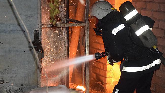 This handout picture taken and released by Ukrainian Emergency Service on July 31, 2022 shows a firefighter pushing out a fire in a building after shelling in Mykolaiv. Picture: UKRAINIAN EMERGENCY SERVICE/AFP