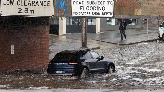 A car drives through floodwaters in South Melbourne. Picture: Jason Edwards