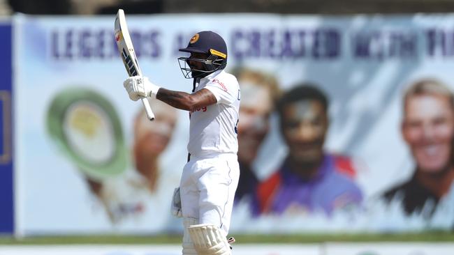 Niroshan Dickwella raises his bat after reaching his 50. Picture: Buddhika Weerasinghe/Getty