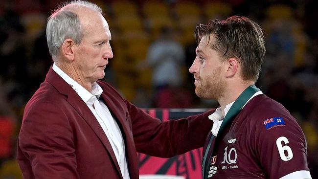 BRISBANE, AUSTRALIA - NOVEMBER 18:  Cameron Munster of the Maroons is presented with the man of the match award by  Maroons coach Wayne Bennett after game three of the State of Origin series between the Queensland Maroons and the New South Wales Blues at Suncorp Stadium on November 18, 2020 in Brisbane, Australia. (Photo by Bradley Kanaris/Getty Images)
