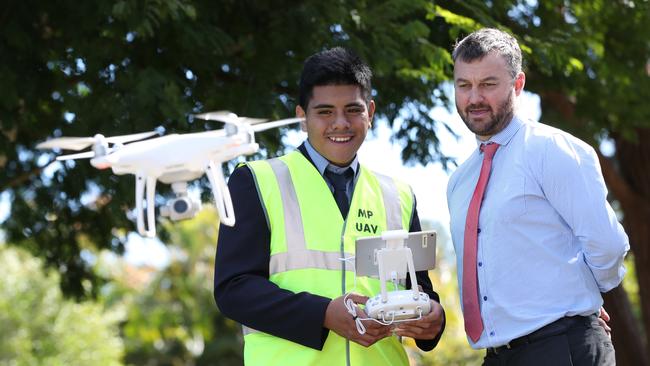 Mabel Park State High School Year 12 student Xavier Foo-Chong, 17, with principal Mick Hornby fly a drone at the school. PHOTO: Peter Wallis