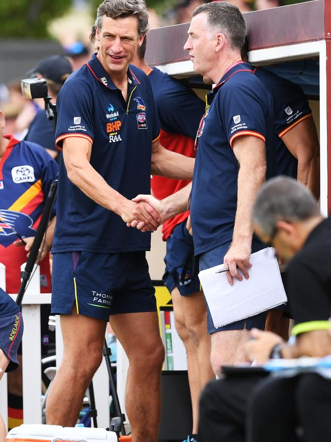 Crows coach Matthew Clarke is congratulated by assistant Peter Cavan after the Crows’ defeat of GWS at Unley Oval on March 10, 2019. Picture: Mark Brake/Getty Images