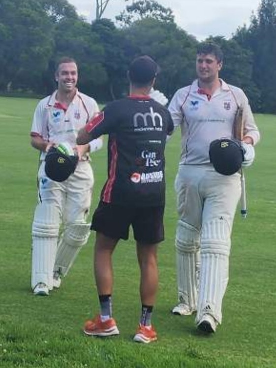 Tom Morris (left) and Brad Erasmus (right) are greeted by South Caulfield captain Will Russell after their 428-run stand.