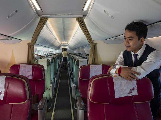 IN FLIGHT - MARCH 04: Ye Myat Aung, a flight attendant, is seen on a near-empty Myanmar National airlines flight from Yangon to Suvarnabhumi International airport on March 04, 2020 in flight. With limited information about cases in some South East Asian countries health experts are worried that the infection could be spreading undetected throughout some parts of the region. The global mortality rate for Covid-19, is 3.4 percent. The Coronavirus has infected roughly 94,000 with 3,221 deaths. (Photo by Paula Bronstein/Getty Images)