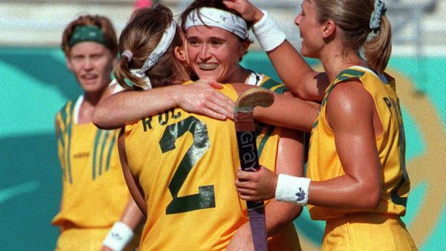 Teammates embrace Danni Roche after scoring a goal during the Atlanta Games.