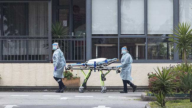 Paramedics wheeling a stretcher outside St Basil’s home for the aged in Fawkner where a COVID-19 Cluster has spread. Picture: David Geraghty