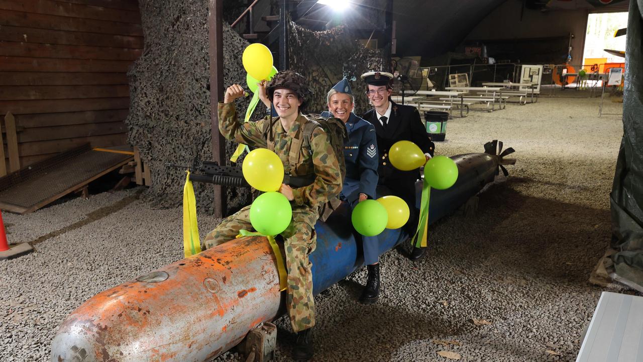 Staff members Balin Biddle, Alicia Withers and Daniel Brodie all dressed up on a torpedo for the Gold Coast War Museum 50th anniversary this Saturday at Mudgeeraba. Picture Glenn Hampson.