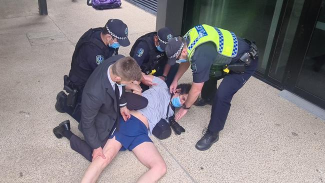 He was then restrained by four police officers after reinforcements arrived. Picture: Andrew Hough