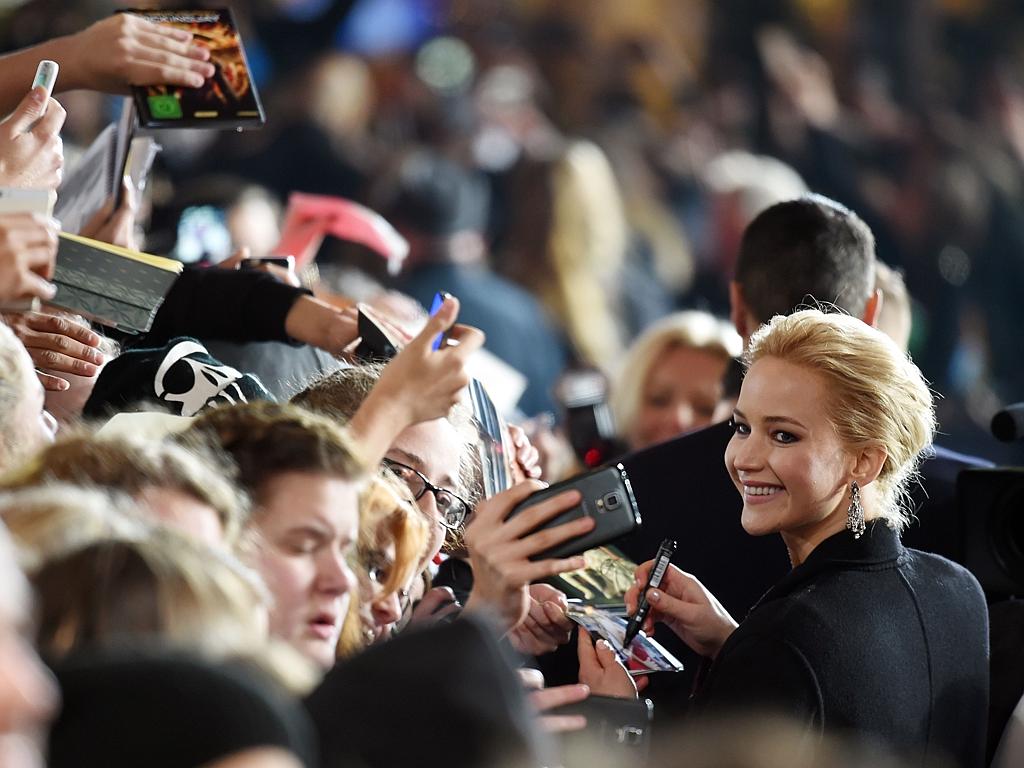 Actress Jennifer Lawrence signs autopraphs for fans as she arrives at the world premiere of the film ‘The Hunger Games: Mockingjay - Part 2’ on November 4, 2015 in Berlin. Picture: AFP