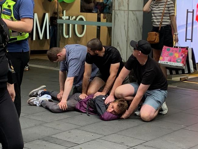 Supplied images of a citizens arrest in Pitt St  in Sydney, today. Witness say a security guard kicked a man out of a Woolies Metro and then he tried to hit the guard before a few others got involved to pin him down. Picture: Supplied,