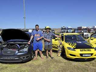 Aaron Cassie with his father Grant Cassie battle it out over which car is better. Picture: Tim Jarrett