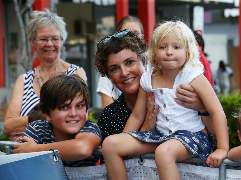 Jamie Edkins, 12, Carla Wilson and Charlie Maguire, 4, watch the CADCAI dragon dancers perform at the Cairns and District Chinese Association Inc Chinese New Year street festival on Grafton Street. PICTURE: BRENDAN RADKE