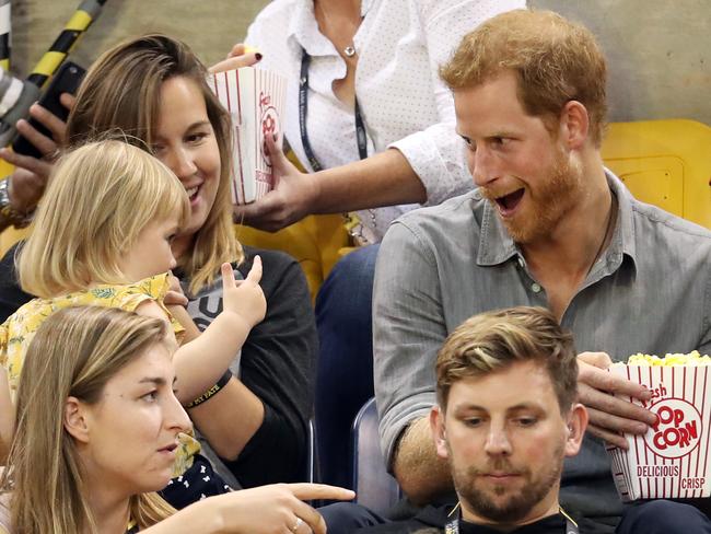 After realising this adorable child was blissfully chomping away on his popcorn, Harry fights back. Picture: Chris Jackson/Getty Images for the Invictus Games Foundation
