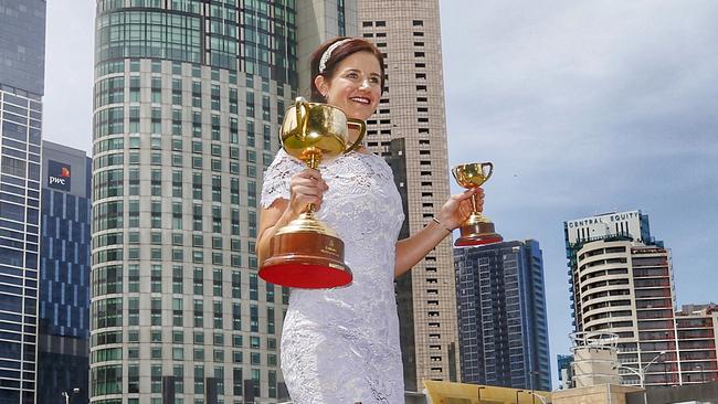 1.06pm. Payne with the cups before boarding a chopper to Kyneton. Picture: Colleen Petch.