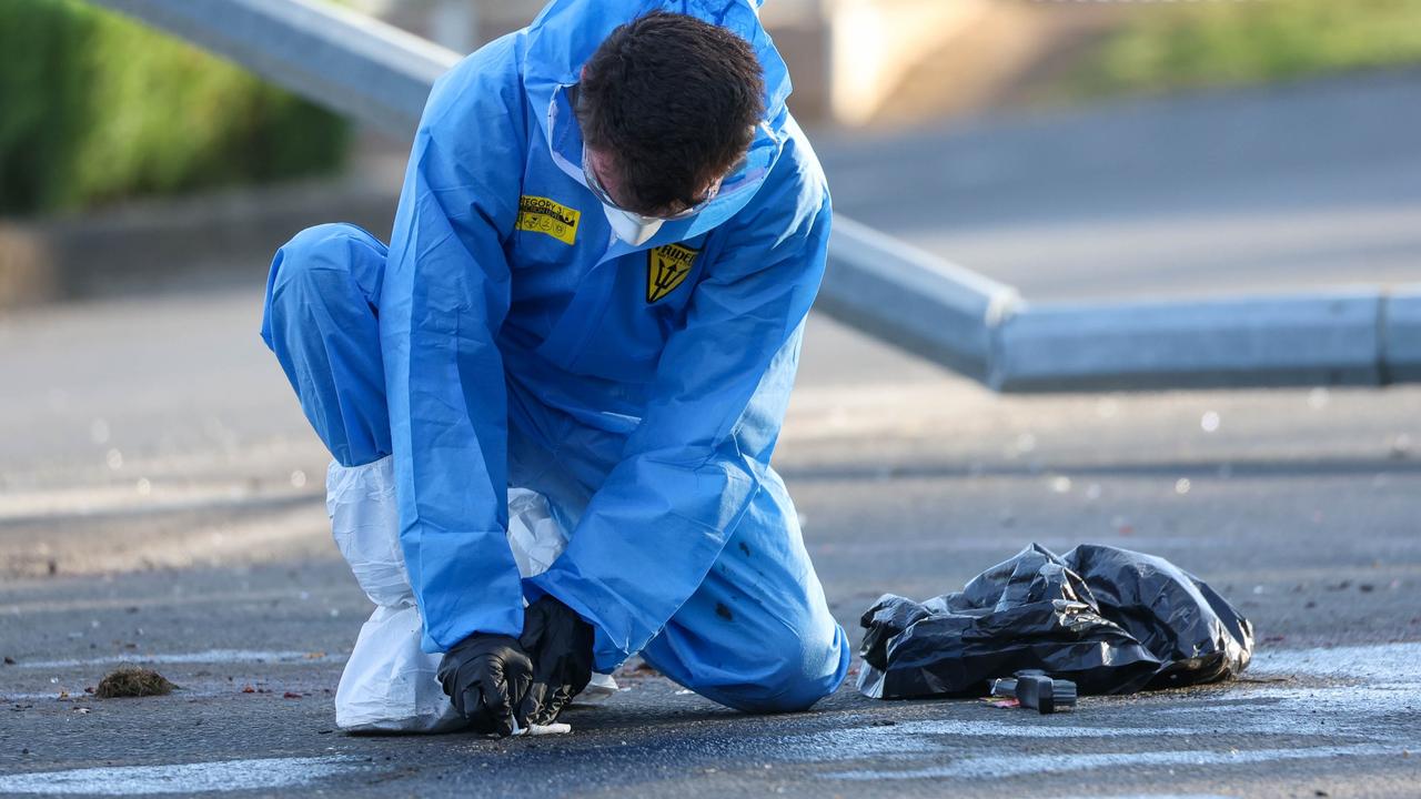 An investigator inspects an item at the scene on Monday. Picture: NCA NewsWire / Brandan Beckett