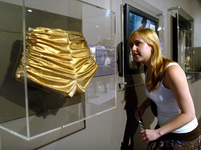 Emma Howarth views infamous gold hot pants worn by singer Kylie Minogue at Sydney's Powerhouse Museum during exhibition of singer's costumes.