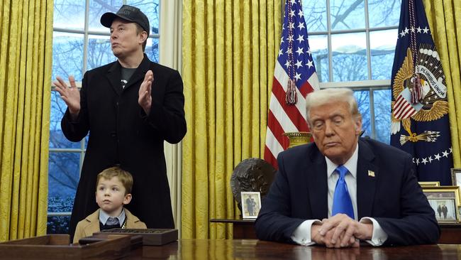 President Donald Trump listens as Elon Musk, with his son X, speaks in the Oval Office at the White House in February. Picture: AP