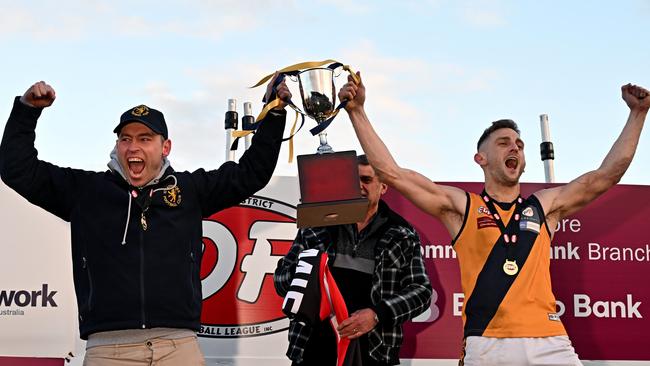 Strathmore coach Matt Horne and captain hold the premiership cup after winning the EDFL Premier Division last year. The team faces a challenge to retain the title this year. Picture: Andy Brownbill