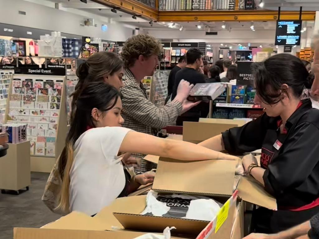 Staff unpack books from boxes on the shop’s floor to meet demand. Picture: Instagram/@dymocksbooks