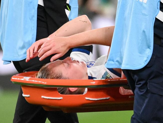 England's midfielder #04 Keira Walsh (C) reacts as she is taken off on a stretcher after an injury during the Australia and New Zealand 2023 Women's World Cup Group D football match between England and Denmark at Sydney Football Stadium in Sydney on July 28, 2023. (Photo by FRANCK FIFE / AFP)