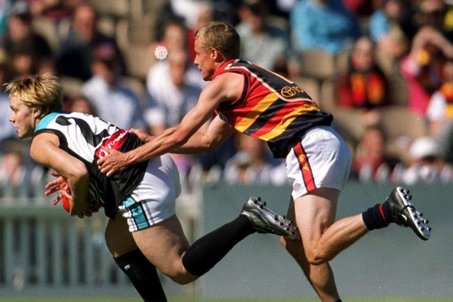 Australian tennis player Lleyton Hewitt (r) tackling Erin Phillips during the Adelaide Crows vs Port Adelaide Power fundraiser match in 2005.
