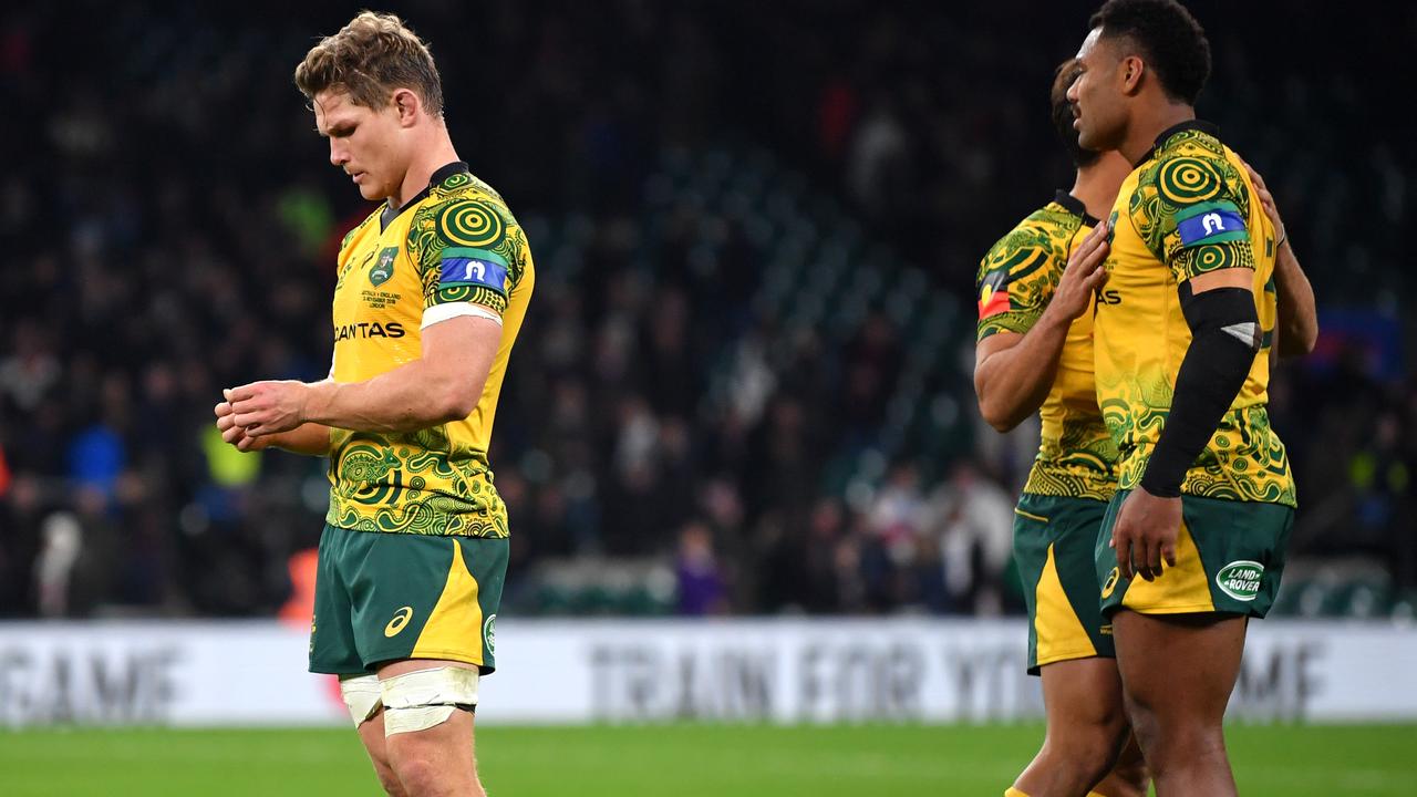 Michael Hooper of Australia looks dejected as Nick Phipps and Samu Kerevi speak.