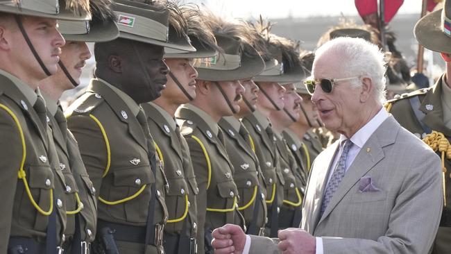 King Charles III, right, gestures beside honour guards during his visit to Sydney Opera House.