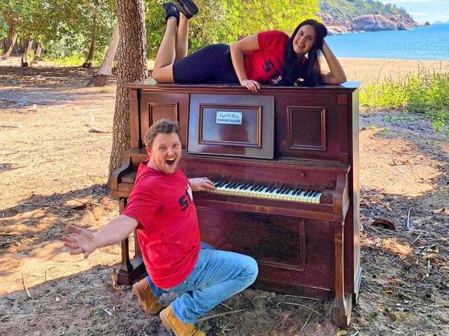 Star 106.3's Brady Ellis and Crystal Vas with the piano they delivered to Radical Bay, Magnetic Island in July. It has since been destroyed.