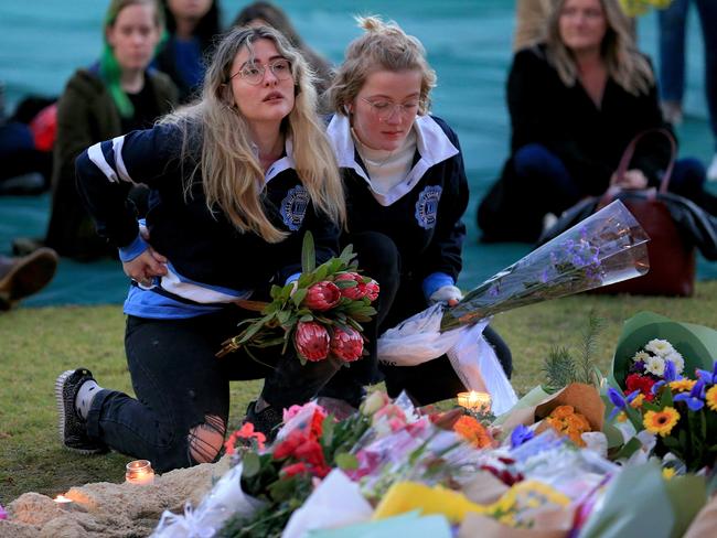 Former Princes Hill Secondary College friends lay flowers for Eurydice Dixon. Picture: Mark Stewart