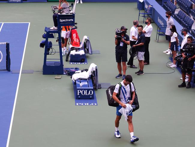 Novak Djokovic walks off the court after being defaulted due to striking line judge Laura Clark. Picture: AFP