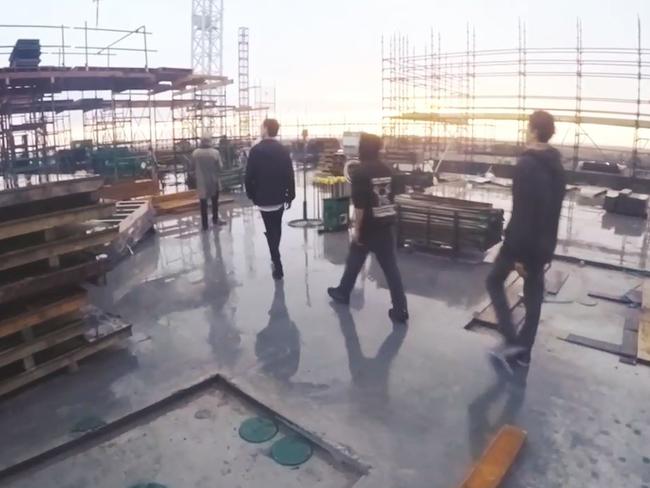 The men on the building’s roof. Picture: Alfie Nevin