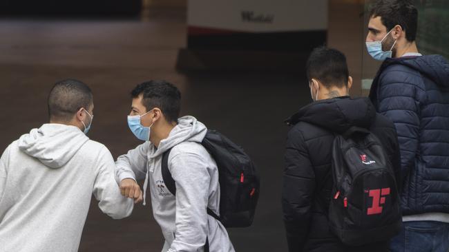 Friends greet each other at the front of Westfield Bondi Junction. Picture: Getty Images.