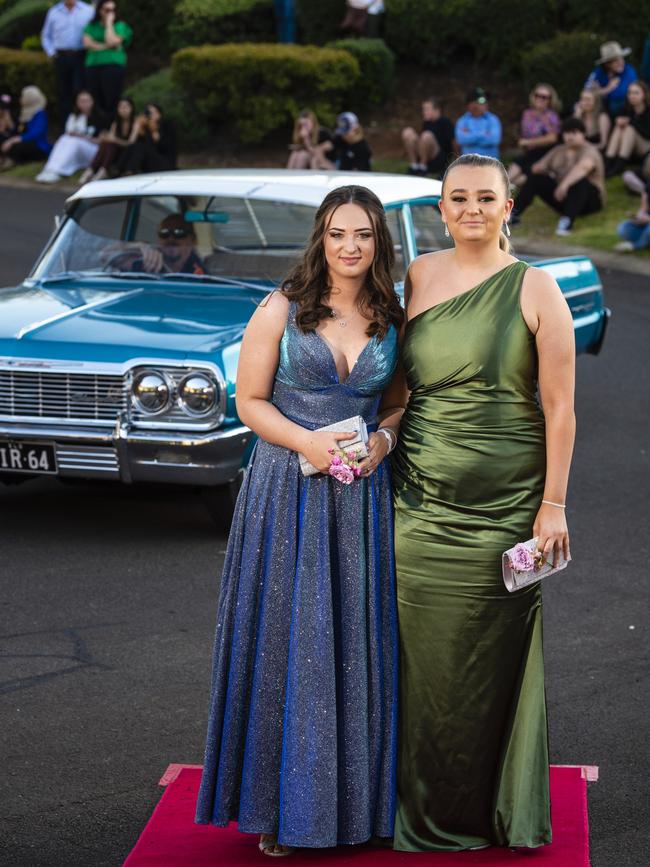 Emilie Hynes (left) and Tiarna Hess arrive at Harristown State High School formal at Highfields Cultural Centre, Friday, November 18, 2022. Picture: Kevin Farmer