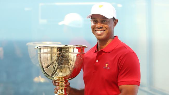 Tiger Woods poses with the Presidents Cup in Melbourne, where he will next year captain the American team. Pic: Michael Klein