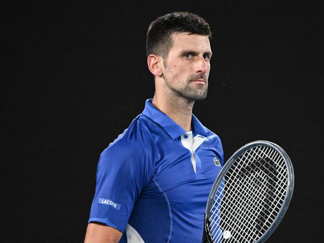 TOPSHOT - Serbia's Novak Djokovic celebrates after victory against Argentina's Tomas Etcheverry during their men's singles match on day six of the Australian Open tennis tournament in Melbourne on January 19, 2024. (Photo by WILLIAM WEST / AFP) / -- IMAGE RESTRICTED TO EDITORIAL USE - STRICTLY NO COMMERCIAL USE --