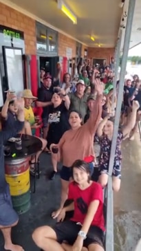 WATCH Dozens of patrons brave floodwaters in their dinghies for a beer