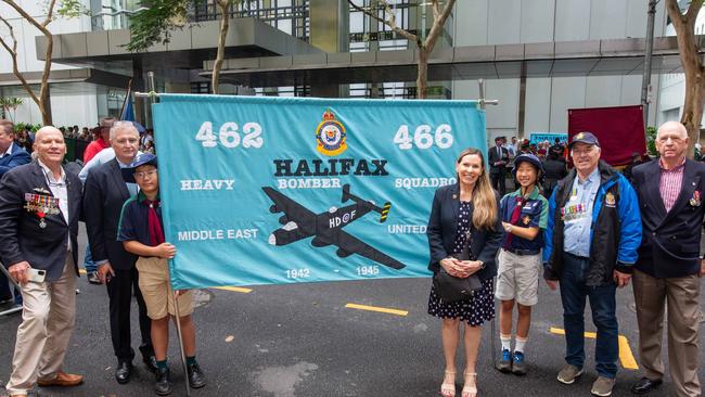 Thousands of people have braved the rain to gather in Brisbane for Anzac Day services. Picture: Grace Kessels