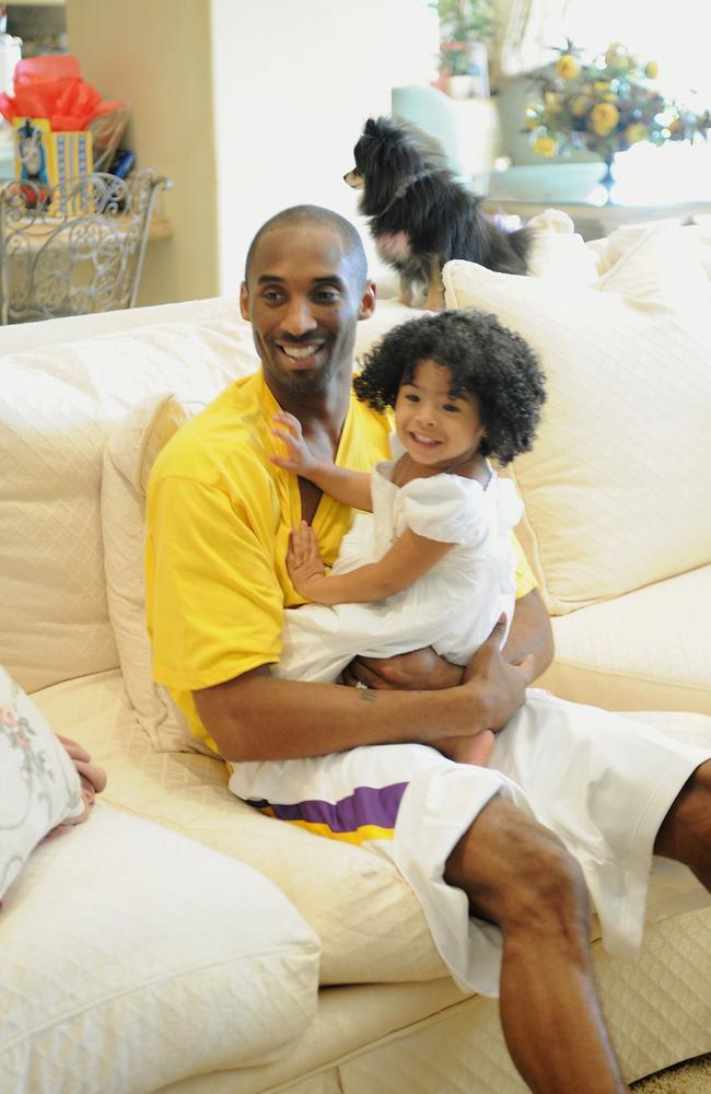 Kobe Bryant of the Los Angeles Lakers holds his daughter Gianna Bryant during a photo session on March 29, 2008 at his home in Newport Beach, California. Picture: Getty