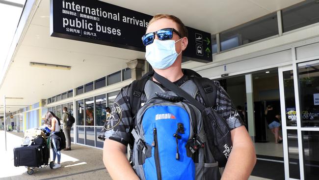 Leaving the Gold Coast Airport with a face mask, Mark Moyle arrives back from Vietnam amid the coronavirus crisis. Photo: Scott Powick.