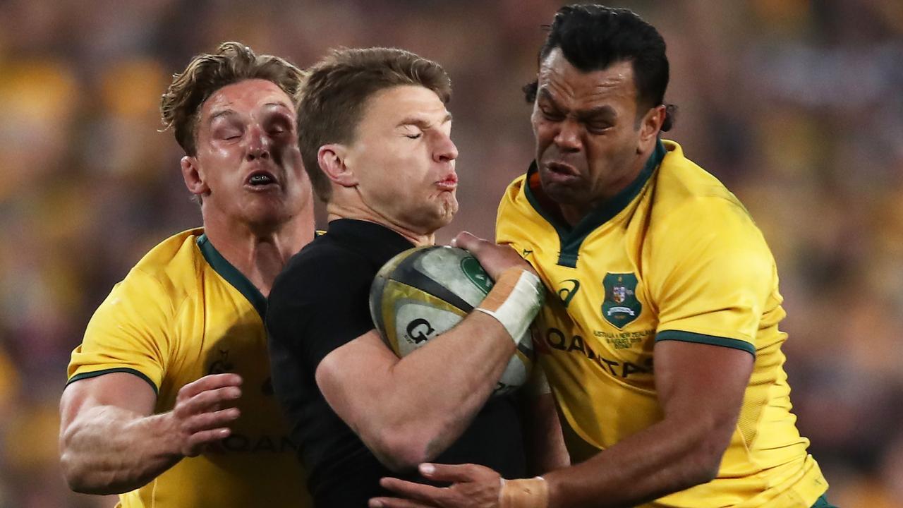 Beauden Barrett of the All Blacks is tackled by Michael Hooper and Kurtley Beale.