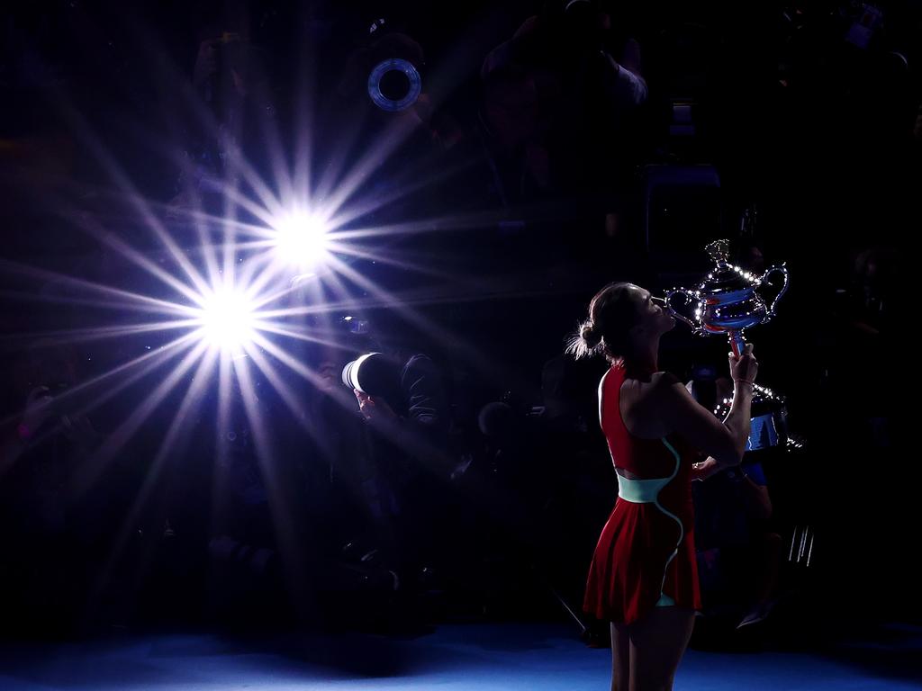 Aryna Sabalenka poses with the Daphne Akhurst Memorial Cup after winning the Women’s Singles Final at the 2024 Australian Open. She triumphed over Qinwen Zheng, securing her place in tennis history. Picture: Getty