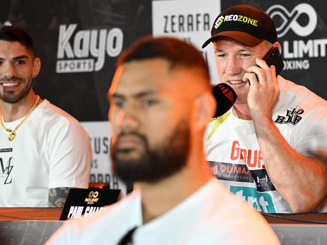 Paul Gallen takes a phone call from Tim Tszyu as Michael Zerafa (far left) watches on. Picture: No Limit Boxing